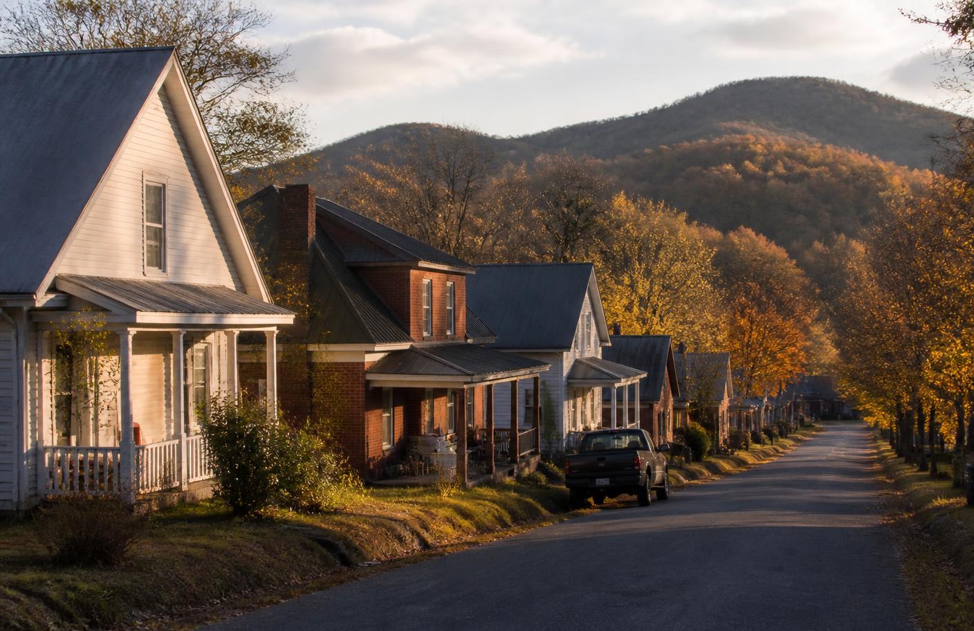 A quiet residential street in a small North Georgia town at golden hour